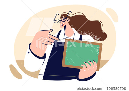 Woman restaurant waiter holds blank chalkboard and with smile points finger at copy space 106589708