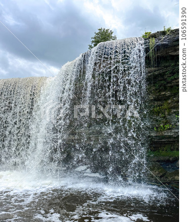 A beautiful big waterfall in Estonia on a clear sunny day A beautiful big waterfall in Estonia on a clear sunny day 106591390