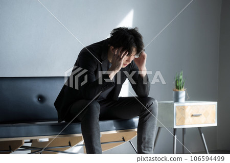 A depressed man sitting on a chair, image of failure in stock investment, FX, virtual currency, etc. A depressed man sitting on a chair, image of failure in stock investment, FX, virtual currency, etc. 106594499