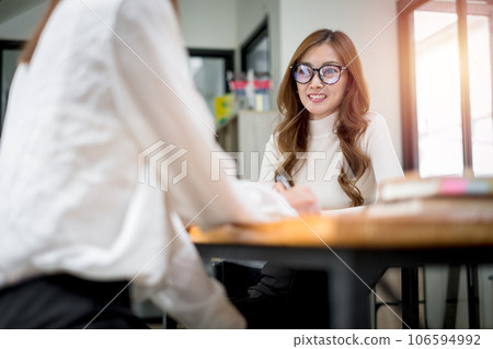 Smiling diverse employees colleagues have fun laugh cooperate brainstorm on computer at office team meeting. Happy multiethnic businesspeople work together on laptop discuss business ideas in group. 106594992