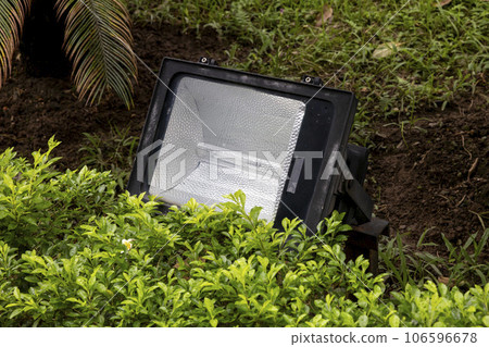 Square floodlights with HID lamps installed in landscaping 106596678