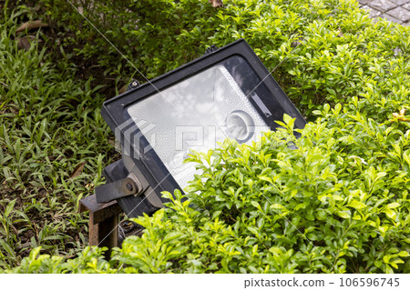 Square floodlight lighting equipment installed in landscaping Square floodlight lighting equipment installed in landscaping 106596745