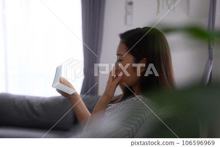 Young woman looking at bank passbook Young woman looking at bank passbook 106596969