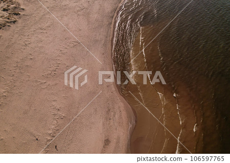 Drone aerial view of waves sea ocean coast. Beach and dunes dark calm sea waves nature landscape captured with drone. Tourism Drone aerial view of waves sea ocean coast. Beach and dunes dark calm sea waves nature landscape captured with drone. Tourism 106597765