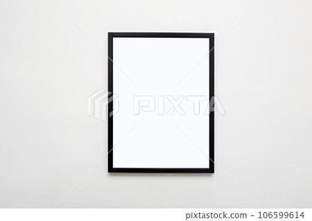 black picture frame on white wall. Stylish modern photoframe 106599614