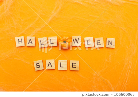the inscription halloween sale with little pumpkin on orange background with spider web the inscription halloween sale with little pumpkin on orange background with spider web 106600063