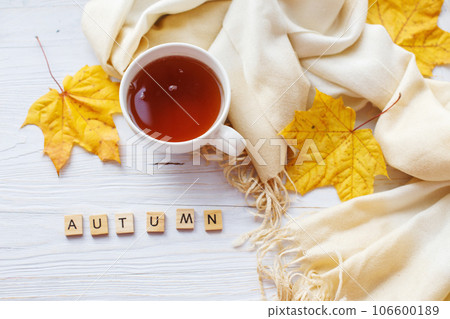 autumn leaves with a cup of tea or coffee next to a scarf on a wooden background with copy space autumn leaves with a cup of tea or coffee next to a scarf on a wooden background with copy space 106600189