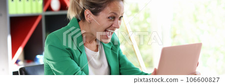 Smiling excited woman holding laptop and looking at screen with happiness 106600827