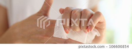 Female cleaning hands using antiseptic wet wipe, personal hygiene 106600854