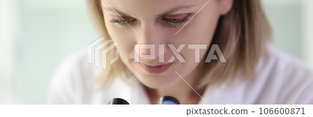 Woman scientist is working in laboratory with microscope. 106600871