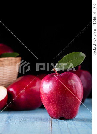 Red apples with leaves on the table 106601178
