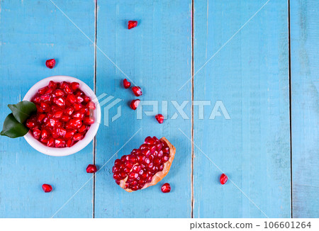 Ripe pomegranate fruits on the wooden background 106601264