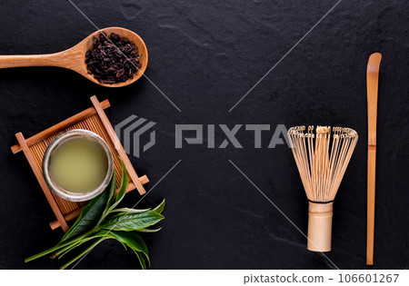 Top view of green tea matcha in a bowl on wooden surface Top view of green tea matcha in a bowl on wooden surface 106601267