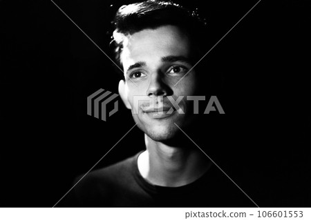 black and white portrait of a young guy on a black background black and white portrait of a young guy on a black background 106601553