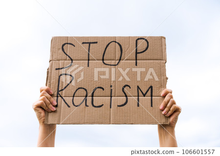 banner in hand stop racism against the sky 106601557