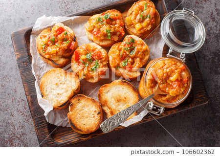 Spicy appetizer dip of eggplant, tomatoes, onions, bell peppers and garlic closeup. Horizontal top view 106602362