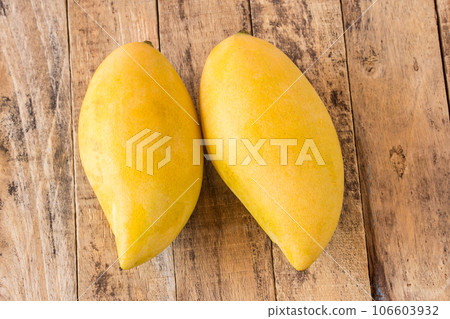 Mango fruit on old wooden table Mango fruit on old wooden table 106603932