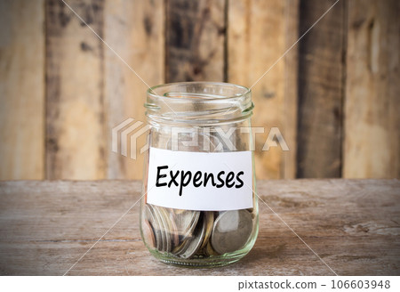 Coins in glass money jar with expenses label, financial concept. 106603948