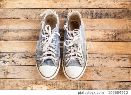 Old shoes on wooden floor 106604310