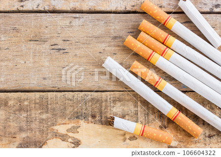 Cigarette roll on old wooden table 106604322