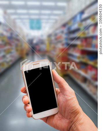 Hand holding smart phone with blur background 106604330