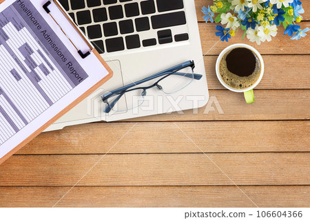 Laptop computer,and coffee on office wood table. Laptop computer,and coffee on office wood table. 106604366