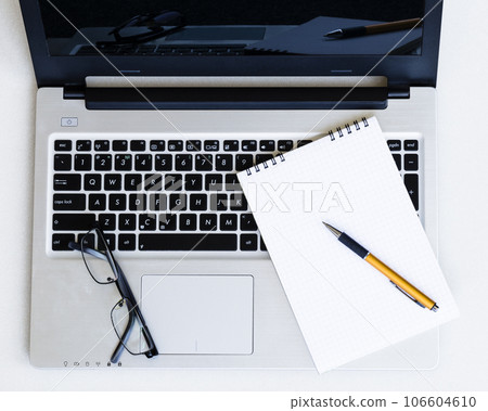 Laptop, notepad and glasses Laptop, notepad and glasses 106604610