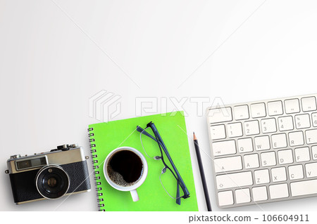 Cup of coffee,notebook,glasses,mini keyboard and vintage camera on white background 106604911