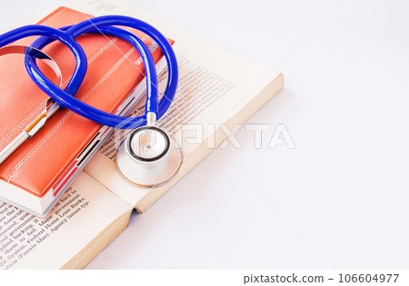 Stethoscope on a pile of books 106604977