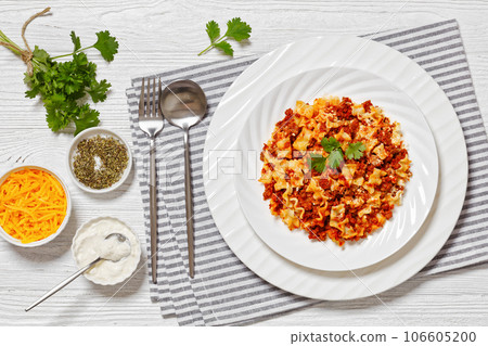 Lasagnette bolognese on white plate, top view 106605200