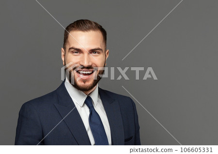 Portrait of successful businessman on grey studio wall background 106605331
