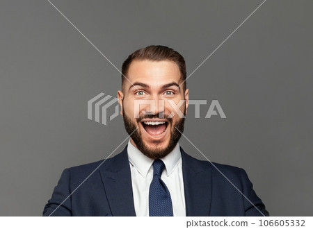 Young happy businessman with really impressive achievements screaming with happiness 106605332
