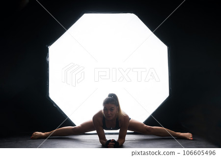 Fit body. Young beautiful female fitness trainer doing workout in a studio Fit body. Young beautiful female fitness trainer doing workout in a studio 106605496