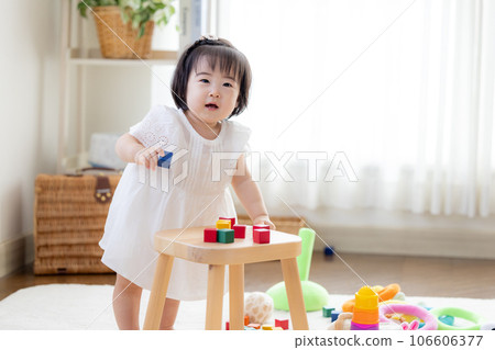 Family girl playing with building blocks Family girl playing with building blocks 106606377