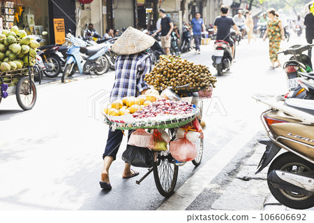 A woman selling fruits from a bicycle seen in Hanoi Old Quarter 106606692