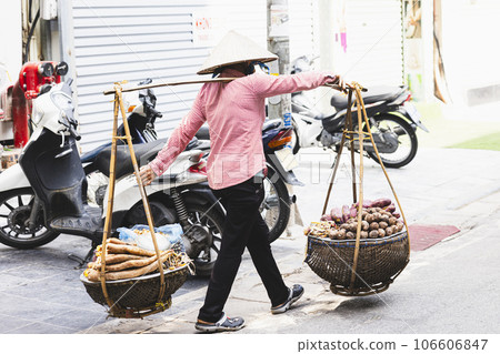 Rear view of a woman selling grain taken in Hanoi's Old Quarter Rear view of a woman selling grain taken in Hanoi's Old Quarter 106606847