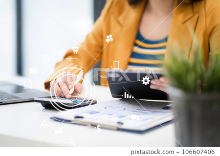 Business woman working on laptop and accounting financial report, accountant using calculator to calculate tax refund at office. Business woman working on laptop and accounting financial report, accountant using calculator to calculate tax refund at office. 106607406