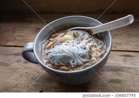 Cloes up photo of fish maw in a bowl on wooden table. Cloes up photo of fish maw in a bowl on wooden table. 106607745