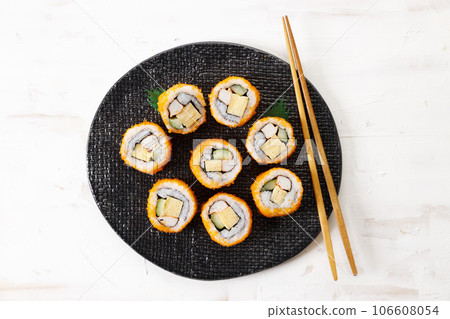 sushi rolls with crab, Japanese omelette and cucumber on a plate. sushi rolls with crab, Japanese omelette and cucumber on a plate. 106608054