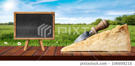 Slice of Italian Parmesan Cheese with Knife and Empty Blackboard 106609218