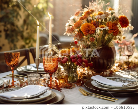 Beautiful fall table setting, autumn dinner table decoration with flowers and candles, holiday event decor in orange and yellow colors 106610553