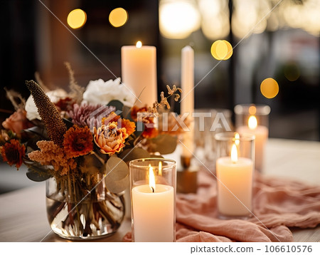 Beautiful fall table setting, autumn dinner table decoration with flowers and candles, holiday event decor in orange and yellow colors 106610576