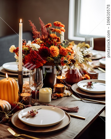 Beautiful fall table setting, autumn dinner table decoration with flowers and candles, holiday event decor in orange and yellow colors 106610578