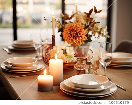 Beautiful fall table setting, autumn dinner table decoration with flowers and candles, holiday event decor in orange and yellow colors 106610579