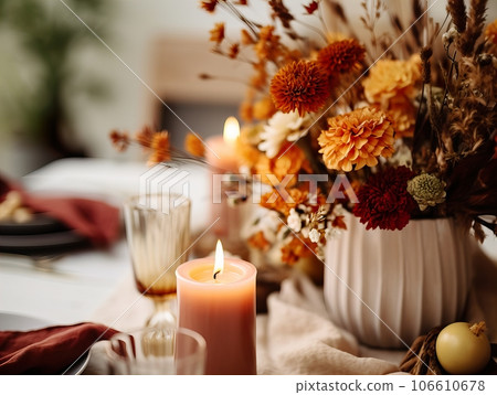 Beautiful fall table setting, autumn dinner table decoration with flowers and candles, holiday event decor in orange and yellow colors 106610678