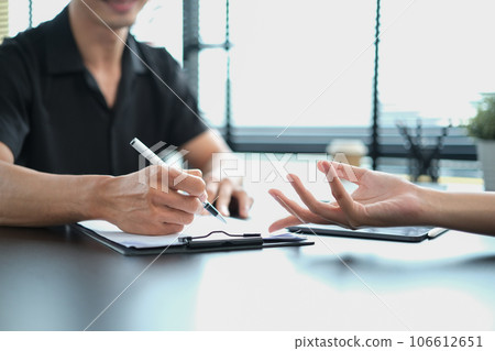 Cropped shot of human resources manager helping new employee to fill and sign employment agreement 106612651