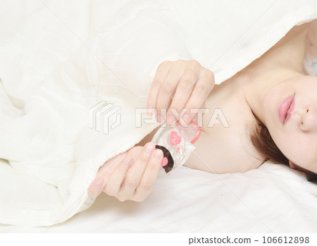 young woman with a condom young woman with a condom 106612898