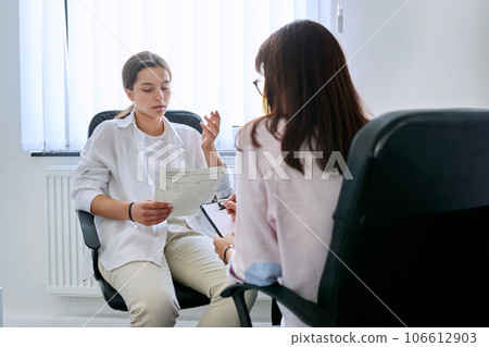 Girl teenager at therapy meeting with professional psychologist 106612903