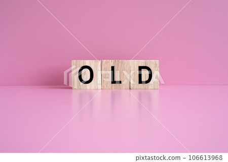 Wooden blocks form the text "OLD" against a pink background. 106613968