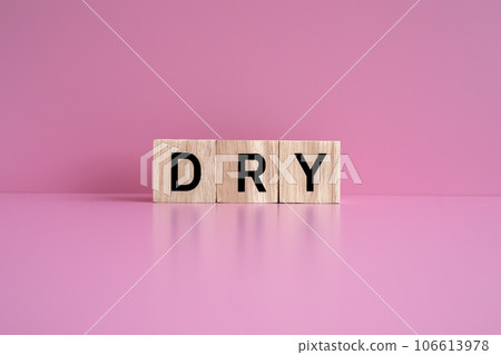 Wooden blocks form the text "DRY" against a pink background. Wooden blocks form the text "DRY" against a pink background. 106613978